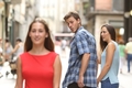Disloyal man with his girlfriend looking at another girl.jpg